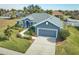 Single-story home with gray exterior, landscaping, and driveway at 4545 Mandolin Blvd, Winter Haven, FL 33884