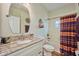 Bathroom with granite countertop, white cabinets, and a shower/tub combo at 4545 Mandolin Blvd, Winter Haven, FL 33884