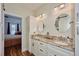 Double vanity bathroom with granite countertop and walk-in shower at 4545 Mandolin Blvd, Winter Haven, FL 33884