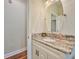 Small bathroom with granite countertop, white cabinets, and a single sink at 4545 Mandolin Blvd, Winter Haven, FL 33884