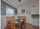 Charming dining area with wood table and bench seating, and modern light fixture at 4545 Mandolin Blvd, Winter Haven, FL 33884