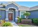 Inviting entryway with a wood door and decorative lighting at 4545 Mandolin Blvd, Winter Haven, FL 33884