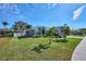 House exterior with a landscaped yard and palm trees at 4545 Mandolin Blvd, Winter Haven, FL 33884