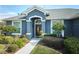 House exterior featuring a covered entryway and lush landscaping at 4545 Mandolin Blvd, Winter Haven, FL 33884