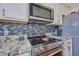 Close-up of a modern kitchen's sleek stovetop and microwave at 4545 Mandolin Blvd, Winter Haven, FL 33884