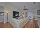 Living room with hardwood floors, a sectional sofa, and a built-in entertainment center at 4545 Mandolin Blvd, Winter Haven, FL 33884