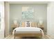 Bedroom with light wood bed frame, neutral bedding, and coastal art at 4826 Yellow Elder Way, Kissimmee, FL 34758