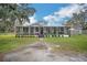 Single-wide manufactured home with covered porch and large yard at 4844 Creek Meadow Trl, Lakeland, FL 33810