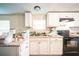 Kitchen area with white cabinets and a double sink at 4844 Creek Meadow Trl, Lakeland, FL 33810