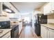 View of the kitchen with white cabinets, granite countertops and black appliances at 4844 Creek Meadow Trl, Lakeland, FL 33810