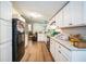 Long view of the kitchen with white cabinets and granite countertops at 4844 Creek Meadow Trl, Lakeland, FL 33810