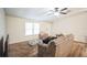 Living room with sofa and TV, featuring wood-look flooring at 4844 Creek Meadow Trl, Lakeland, FL 33810