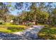 Ranch home with a long driveway and detached garage at 6104 Irby W Ln, Lakeland, FL 33811