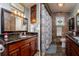 Updated bathroom with granite vanity, tiled shower, and decorative accents at 6104 Irby W Ln, Lakeland, FL 33811