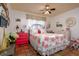 Bright bedroom with floral bedding and terracotta tile floors at 6104 Irby W Ln, Lakeland, FL 33811