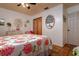 Bright bedroom with floral bedding and terracotta tile floors at 6104 Irby W Ln, Lakeland, FL 33811