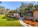 Ranch-style home with brick facade, landscaped yard, and walkway at 6104 Irby W Ln, Lakeland, FL 33811