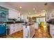 Kitchen features white cabinets, granite counters, and island at 6104 Irby W Ln, Lakeland, FL 33811