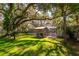 Relaxing pool area with covered patio and lush landscaping at 6104 Irby W Ln, Lakeland, FL 33811