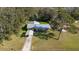 Aerial view of a house showcasing its metal roof, carport, and spacious yard at 1507 Hontoon Rd, Deland, FL 32720