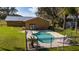 An aerial view of a refreshing in-ground pool, framed by lounge chairs at 1507 Hontoon Rd, Deland, FL 32720