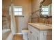 Cozy bathroom featuring a shower/tub combo, decorative mirror, and neutral finishes at 1507 Hontoon Rd, Deland, FL 32720