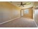 Spacious bedroom with carpet, a ceiling fan, a window and neutral paint at 1507 Hontoon Rd, Deland, FL 32720