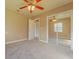 Bedroom with ceiling fan and mirrored closet doors at 1507 Hontoon Rd, Deland, FL 32720