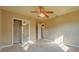 Spacious bedroom with mirrored closet and ceiling fan at 1507 Hontoon Rd, Deland, FL 32720