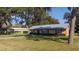 Attractive house with a metal roof, complemented by a convenient carport at 1507 Hontoon Rd, Deland, FL 32720