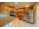 Well-equipped kitchen featuring stainless steel appliances, granite countertops, and custom wood cabinetry at 1507 Hontoon Rd, Deland, FL 32720