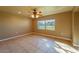 Bright living room featuring neutral paint, tile flooring, a ceiling fan, and a large window at 1507 Hontoon Rd, Deland, FL 32720