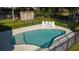 Backyard pool with lounge chairs, surrounded by a metal fence at 1507 Hontoon Rd, Deland, FL 32720