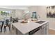 Kitchen island with a white quartz countertop and double sink at 5758 Meditation Dr, Clermont, FL 34714