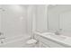 Bright bathroom featuring a tub and shower combo with tiled walls and a single vanity at 1254 Lakeridge Way, Lake Alfred, FL 33850