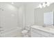 Bright bathroom featuring a tub and shower combo with tiled walls and a single vanity at 1254 Lakeridge Way, Lake Alfred, FL 33850