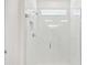 Modern all-white tiled shower with frameless glass door and horizontal subway tile at 1254 Lakeridge Way, Lake Alfred, FL 33850
