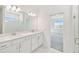 Modern bathroom featuring dual sinks, white cabinets, and a tiled glass shower at 1254 Lakeridge Way, Lake Alfred, FL 33850
