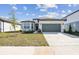 Charming single-story home featuring a two-car garage and well-manicured lawn at 1254 Lakeridge Way, Lake Alfred, FL 33850