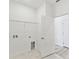 Laundry room with tile flooring, utility connections, and door to hallway at 1254 Lakeridge Way, Lake Alfred, FL 33850