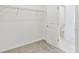 Walk-in closet with carpet, wire shelving, and door leading to bathroom at 1254 Lakeridge Way, Lake Alfred, FL 33850