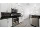 Modern kitchen with white cabinets, granite counters, and stainless steel appliances at 1295 Evergreen Park Cir, Lakeland, FL 33813