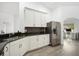 Modern kitchen with white cabinets, granite counters, and stainless steel appliances at 1295 Evergreen Park Cir, Lakeland, FL 33813