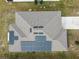 Aerial view of a house with solar panels on the roof at 1734 Hill Top Dr, Dundee, FL 33838