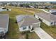 Aerial view of a single story house with solar panels and a two-car garage at 1734 Hill Top Dr, Dundee, FL 33838