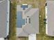 Aerial view of a house with solar panels on the roof at 1734 Hill Top Dr, Dundee, FL 33838