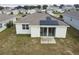 Aerial view of houses with solar panels, showcasing a community at 1734 Hill Top Dr, Dundee, FL 33838