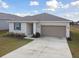 Single story house with solar panels and a two-car garage at 1734 Hill Top Dr, Dundee, FL 33838