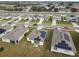 Aerial view of houses with solar panels, showcasing a community at 1734 Hill Top Dr, Dundee, FL 33838