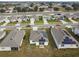 Aerial view of houses with solar panels, showcasing a community at 1734 Hill Top Dr, Dundee, FL 33838